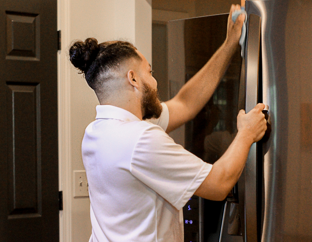Clean by Nature employee performing a standard house cleaning job